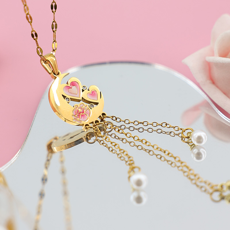 Elegant Moon Tassel Necklace | Long Pearl Drop Pendant Side view of a gold moon necklace showing long chain tassels with white pearl drops reflecting on a mirror.
