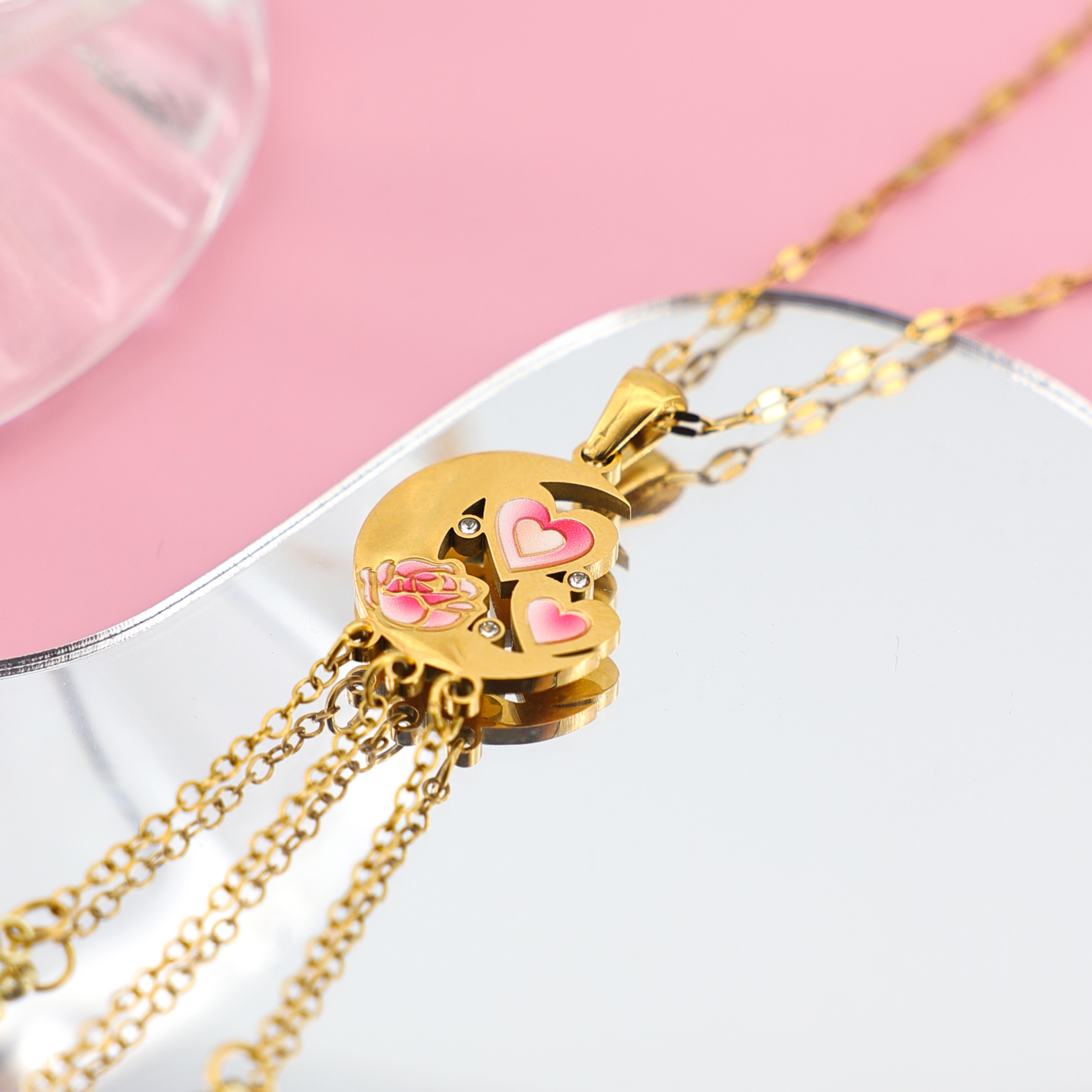 Romantic Moon & Heart Pendant | Celestial Rose Jewelry Gold crescent moon pendant with pink enamel heart and rose details, featuring small crystal accents.